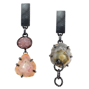 Handmade mismatched earrings in oxidized sterling silver with raw amethyst crystals, agate, and a chalcedony rose mineral specimen on white background.