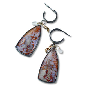 Pair of earrings with large, teardrop-shaped natural stone pendants, gold accents, and Herkimer diamonds on a white background.