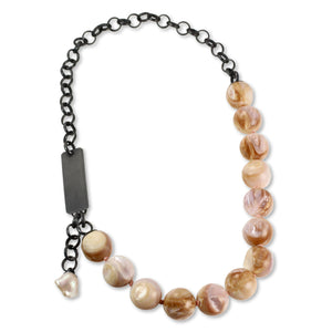 One-of-a-kind shell bauble necklace with oxidized sterling silver chain, front clasp, and small baroque pearl dangle on a white background.