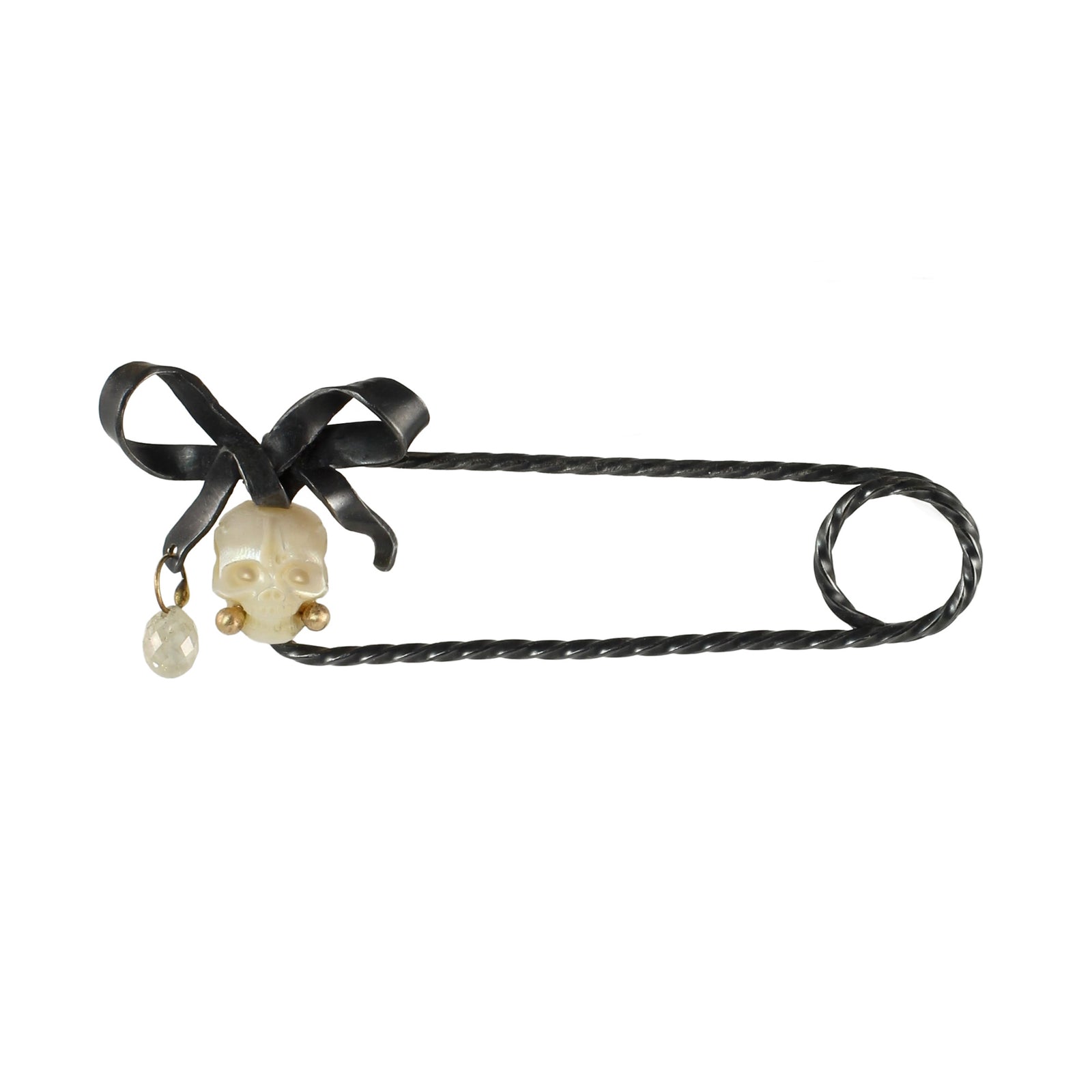 Carved pearl skull fibula pin with silver bow and silver diamond drop with 14k gold accents.