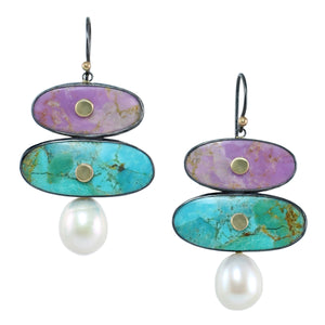 Double stone earrings with lavender phosphosiderite and blue American turquoise, pearl drops, oxidized silver settings, and 14k gold accents on a white background
