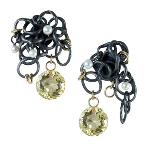 One-of-a-kind Fragments earrings with large faceted citrine drops, pearls, 14k gold fill accents, and organically fused oxidized sterling silver photographed floating on a white background.