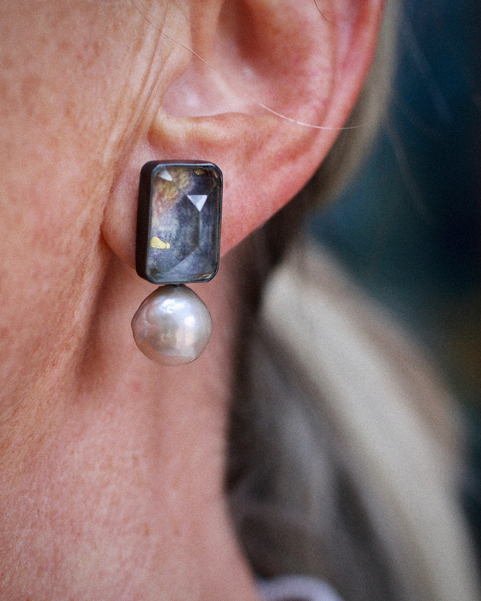 Stud earrings with rectangular vintage glass over layered artwork and champagne pearls, set in oxidized sterling silver on white background