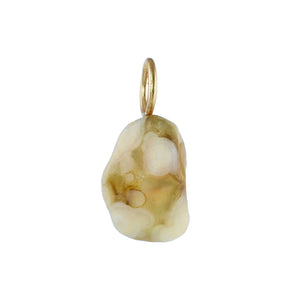 A natural raw Gobi Desert charm with gold, olive green and cream patterning attached to a small gold bail, shown on a plain white background.
