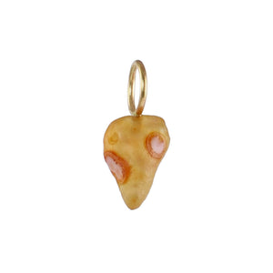 Golden ochre Gobi Desert agate charm with cream and rust-colored orb markings and a recycled 14k gold ring on a white background.