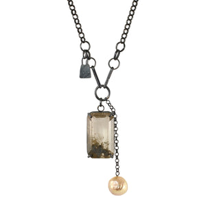 Rutile quartz talisman necklace with baroque pearl and mixed oxidized silver chain on white background.