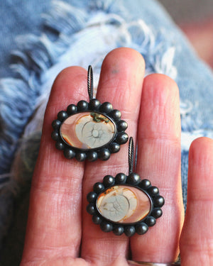 Handmade imperial jasper earrings with oxidized silver bauble frames resting on fingertips to show scale.