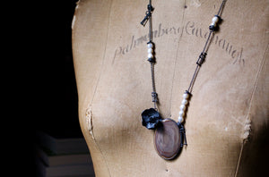 One-of-a-kind imperial jasper and sterling silver orchid necklace with irregular white pearls and architectural silver fragments displayed on a vintage dress form.