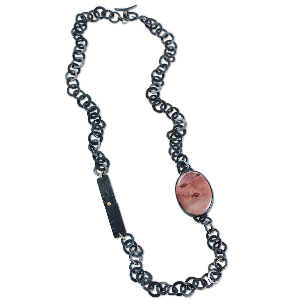 Imperial jasper necklace with oval pink patterned stone, oxidized silver handcrafted chain, and small 14k gold accents on white background.