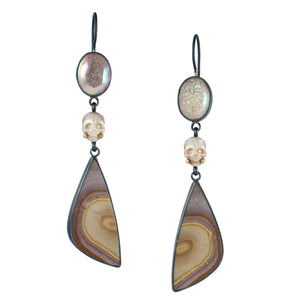 Long Calavera earrings with opalized druzy, carved pearl skulls, polychrome jasper, oxidized sterling silver, and 14k gold accents on a white background.