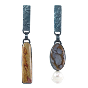 Mismatched Wonderstone and Mushroom Jasper earrings with one baroque pearl, set in oxidized sterling silver with embossed rectangular tabs on a white background.