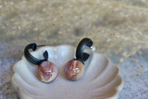 Natural shell hoop earring showing a dark oxidized silver hoop and softly patterned shell drop.