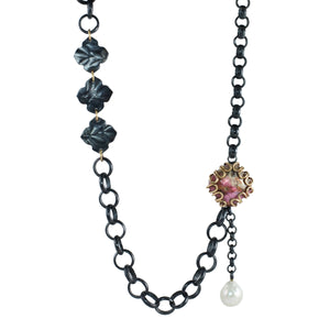 Oxidized sterling silver mixed chain necklace with pink cobalt calcite set in 14k gold loops and a dangling pearl on white background