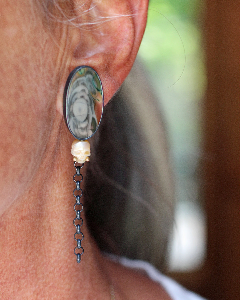 Imperial jasper and carved pearl skull earrings with recycled 14k gold accents and long oxidized sterling silver chain drops on a white background.