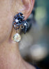 Close-up video of a Fragments earring worn on the ear, with fused oxidized sterling silver, pearls, gold accents, and a large round faceted citrine drop. Shows movement and scale. 