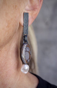 Video of mismatched Wonderstone and Mushroom Jasper earrings with one baroque pearl, set in oxidized sterling silver with embossed rectangular tabs worn.