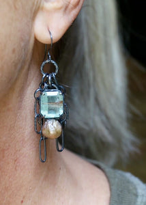 Video of long gemstone chain earrings with aquamarine, pearl, copper rutile quartz, and oxidized sterling silver worn on ear.