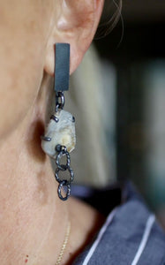 Video of mismatched oxidized silver earrings shown worn, with a chalcedony rose mineral specimen and handmade chain links.