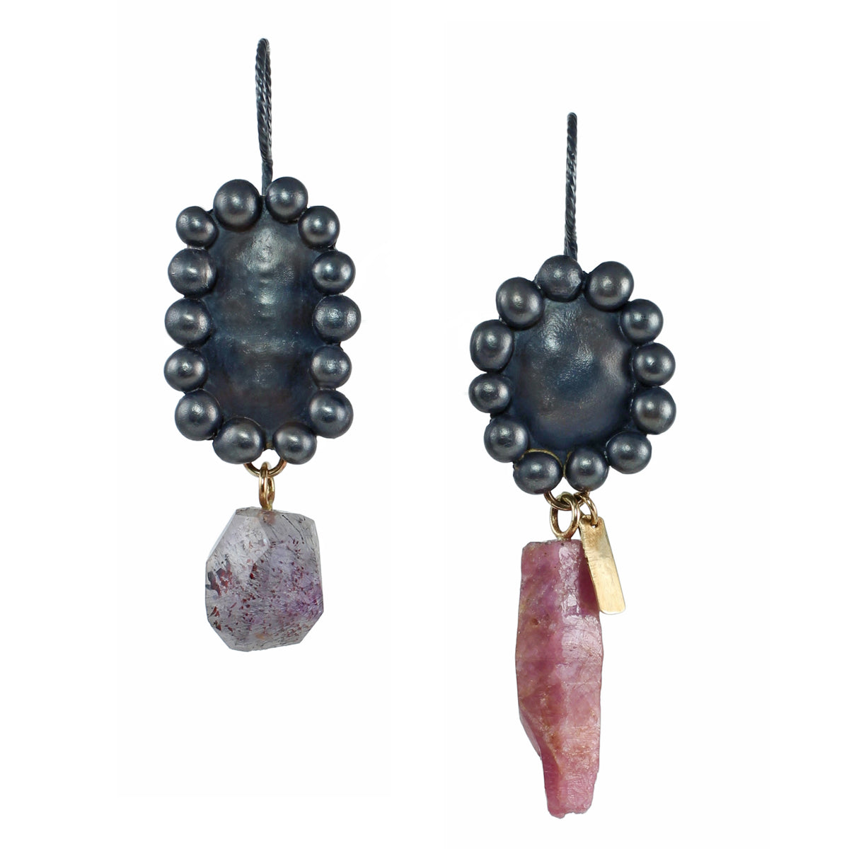 Mismatched raw ruby crystal and melody stone earrings shown on white, with oxidized sterling silver bauble settings and recycled 14k gold details.