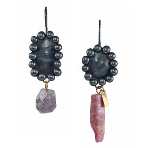 Mismatched raw ruby crystal and melody stone earrings shown on white, with oxidized sterling silver bauble settings and recycled 14k gold details.