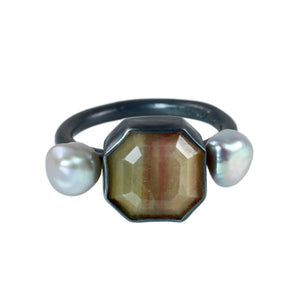 Close-up of faceted golden sapphire ring with soft banding and silver pearls on a clean white background, showing handmade oxidized silver setting